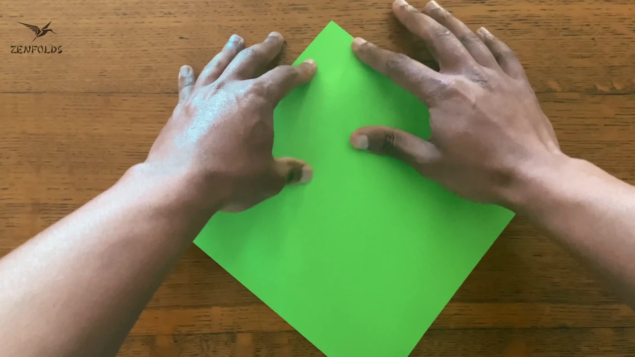 fingers and thumbs being used to create an arbitrary point in preparation for a mountain fold.