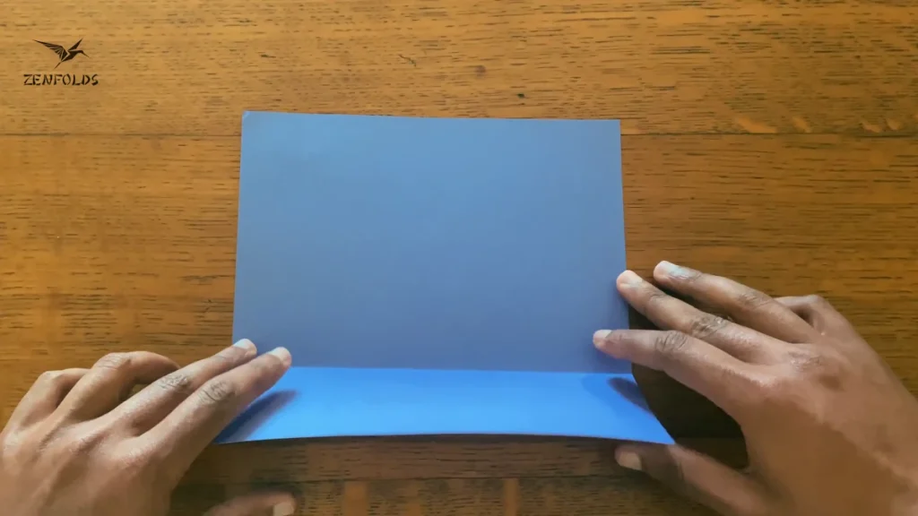 an origami sheet with a completed valley fold