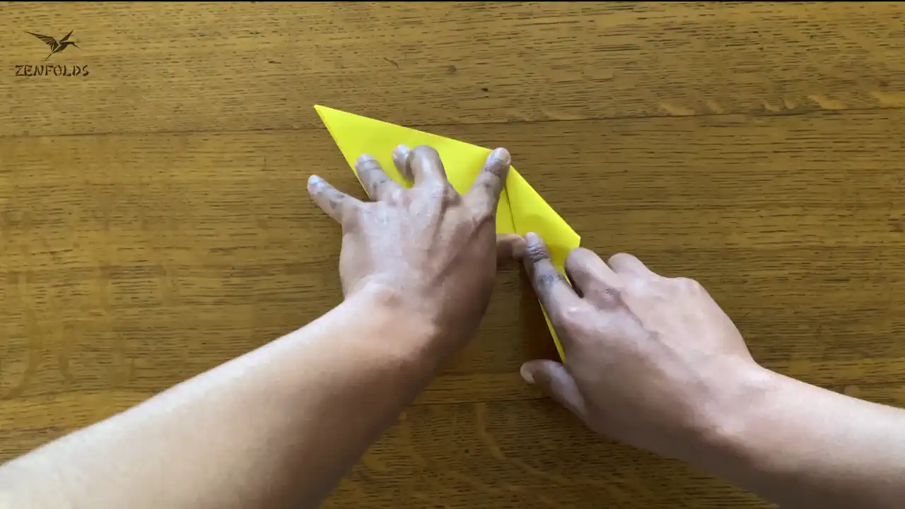 a origami kite folded in half with an arbitrary mountain fold