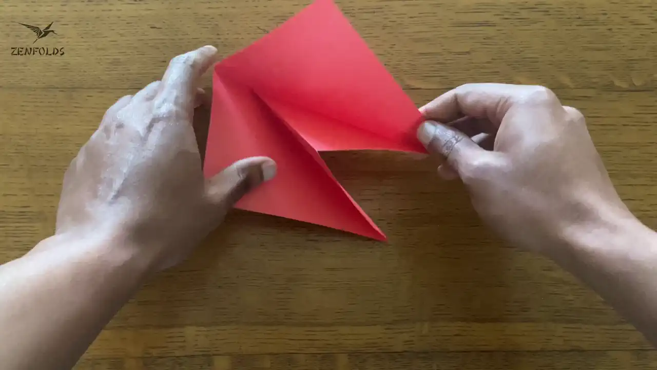 tucking a flap to make an origami inside reverse fold