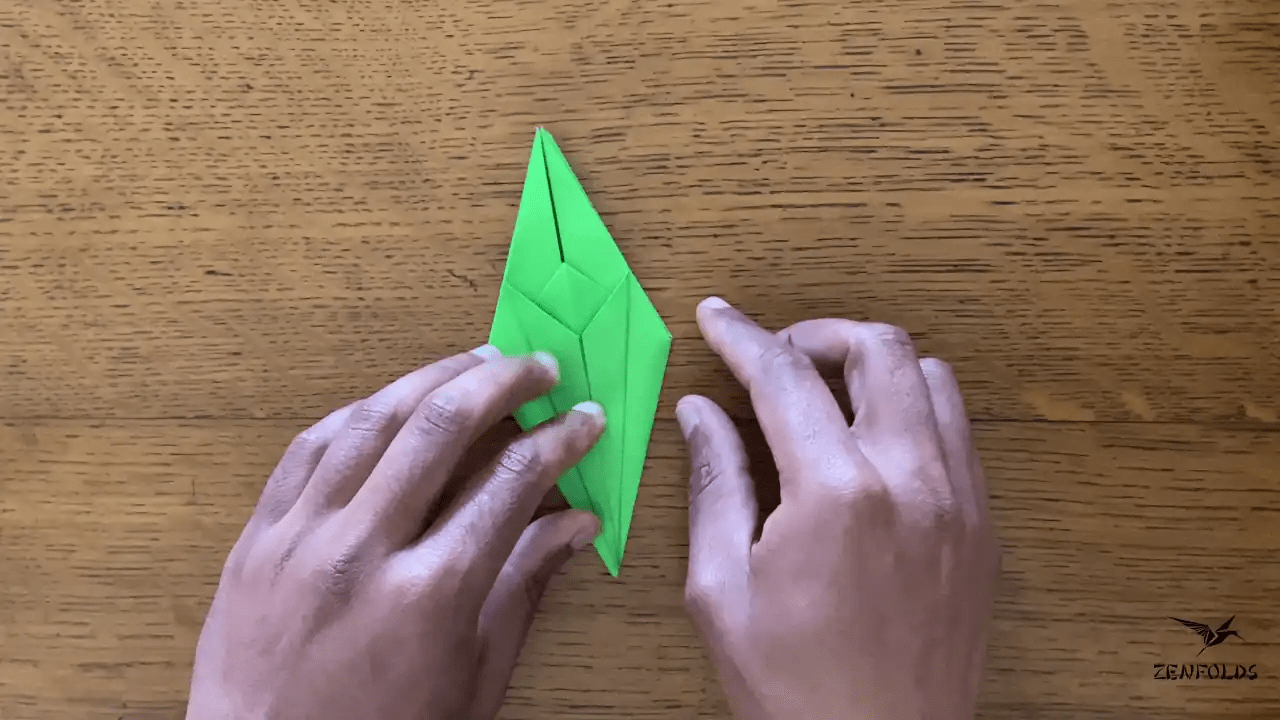 origami frog base being folded into an origami lily