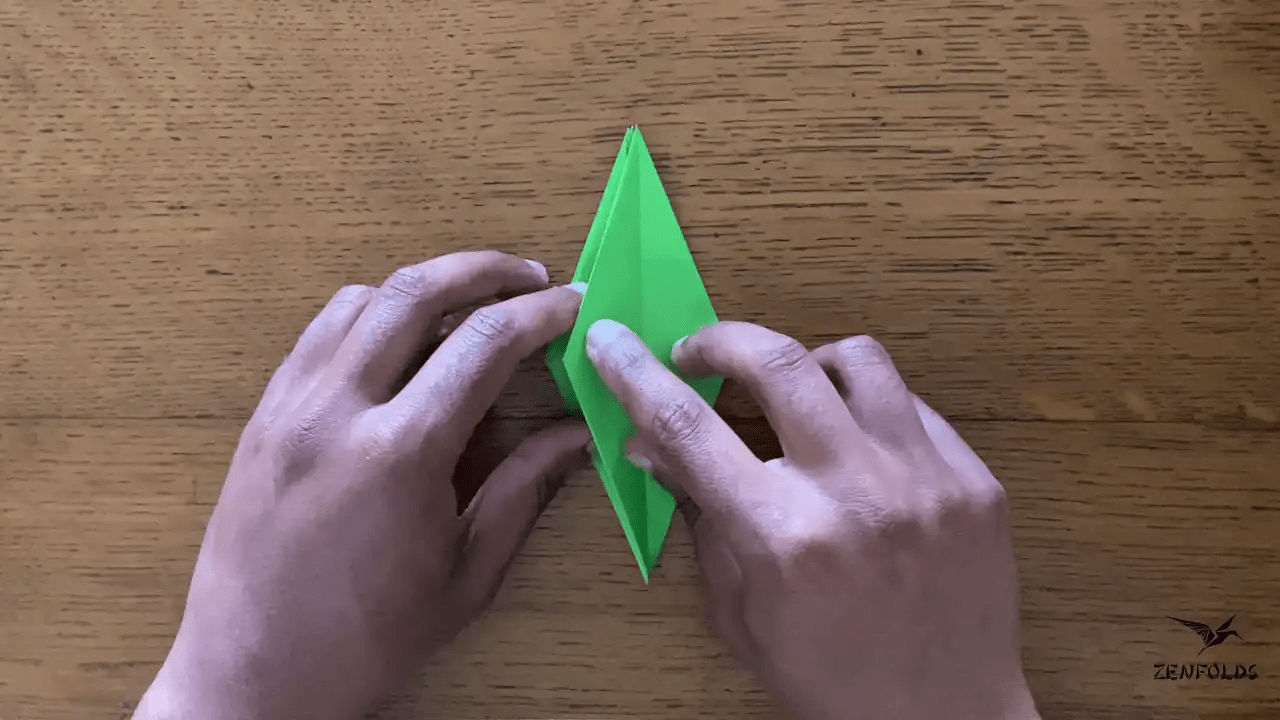 origami frog base being folded into an origami lily