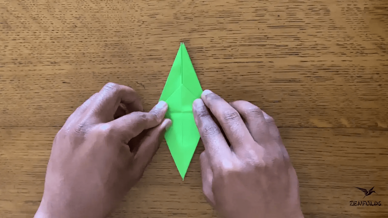 origami frog base being folded into an origami lily