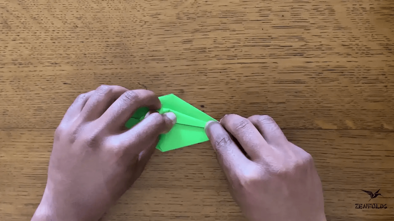 origami frog base being folded into an origami lily