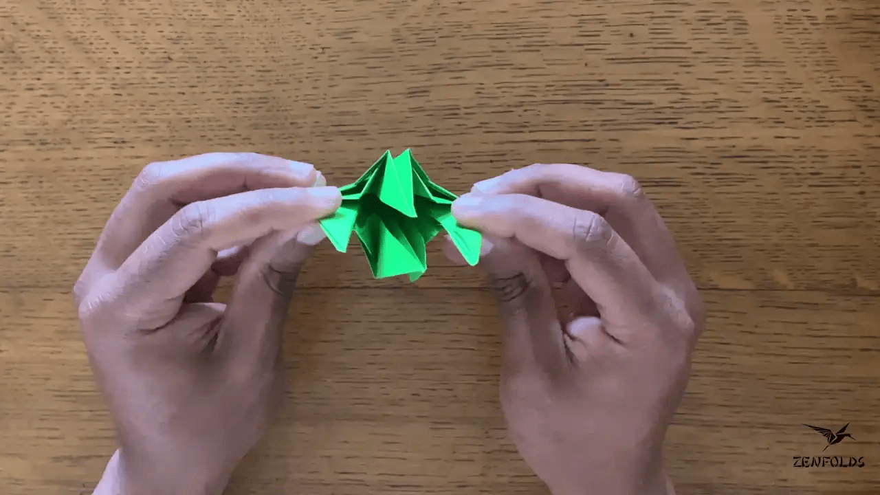 origami frog base being folded into an origami lily