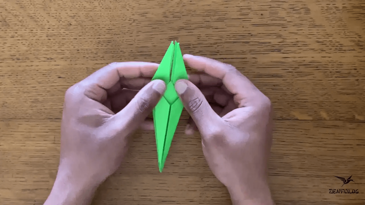 origami frog base being folded into an origami lily