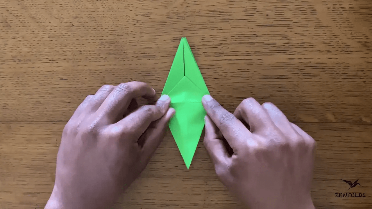 origami frog base being folded into an origami lily