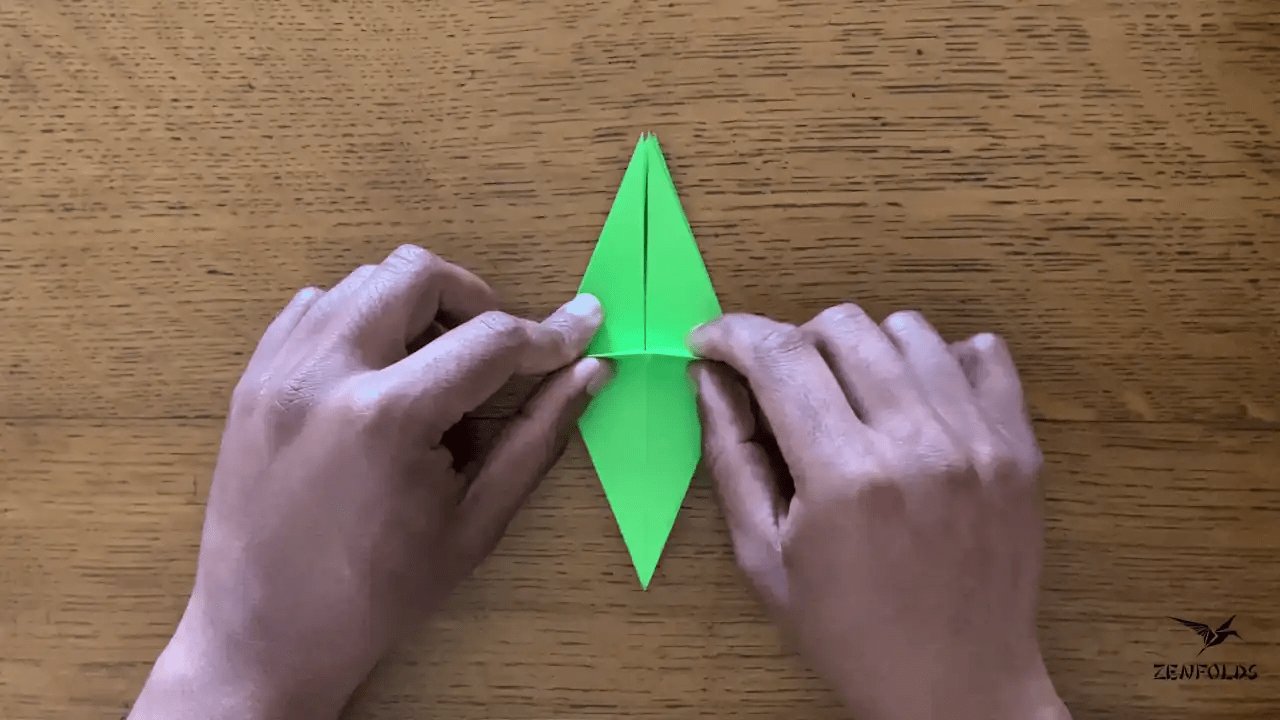 origami frog base being folded into an origami lily