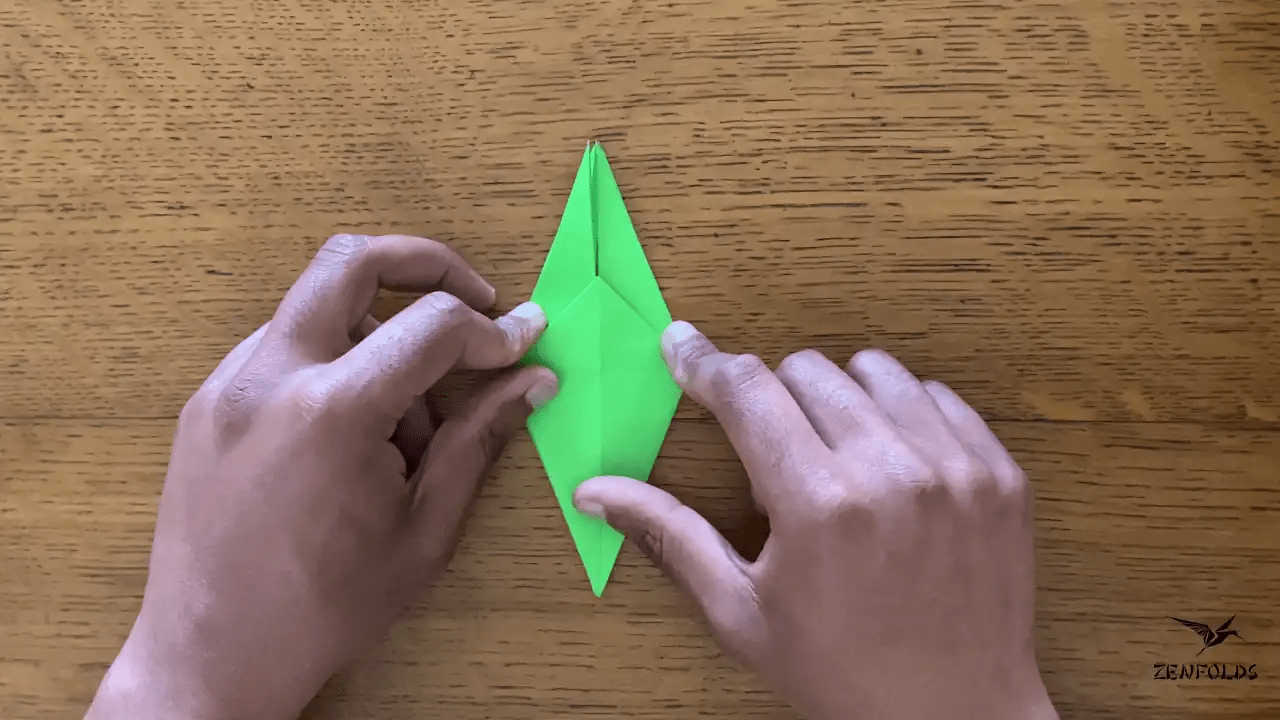 origami frog base being folded into an origami lily