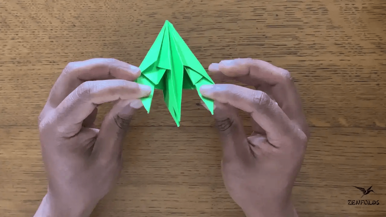 origami frog base being folded into an origami lily